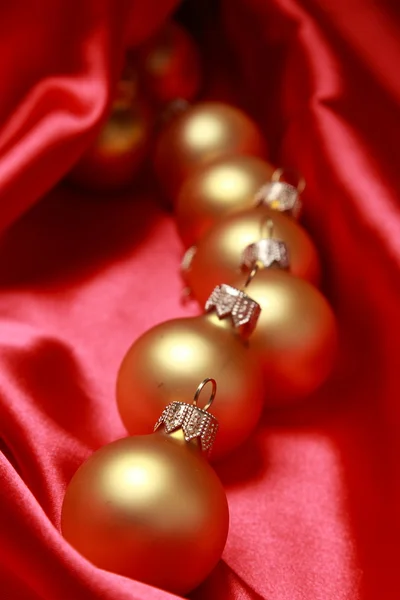 Golden balls over red background — Stock Photo, Image