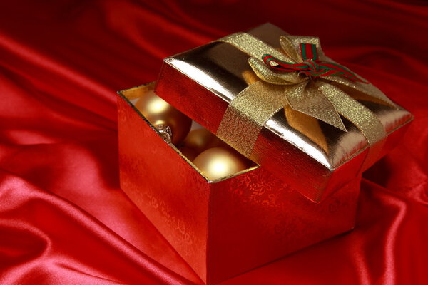 Gift box with golden christmas balls