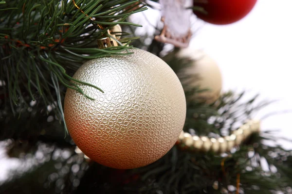 Golden ball on Christmas tree — Stock Photo, Image