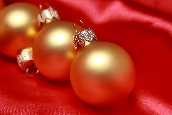 Golden balls over red background — Stock Photo, Image