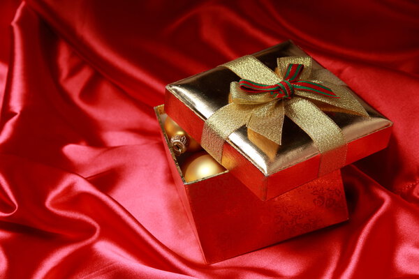 Gift box with golden christmas balls