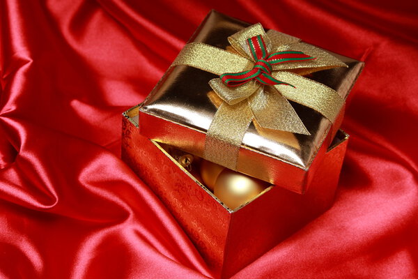 Gift box with golden christmas balls