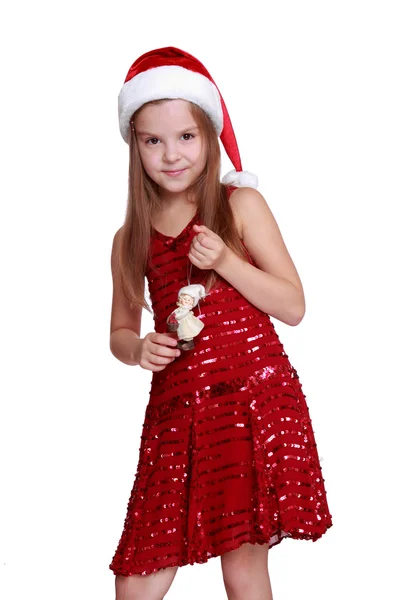Kleines Mädchen mit dekorativer Puppe an Weihnachten — Stockfoto