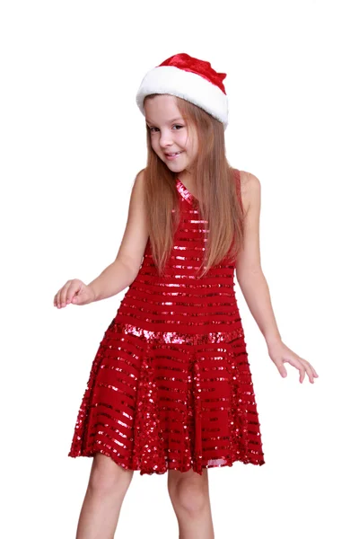 Маленькая девочка в праздничном платье позирует перед камерой — стоковое фото