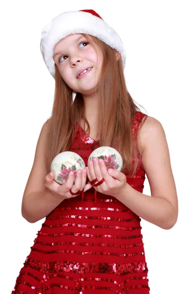 Preschool girl holding Christmas decoration in hands — Stock Photo, Image