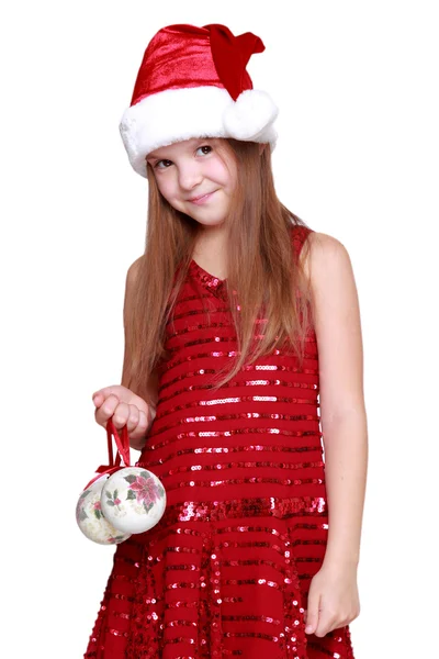 Preschool girl holding Christmas decoration in hands — Stock Photo, Image