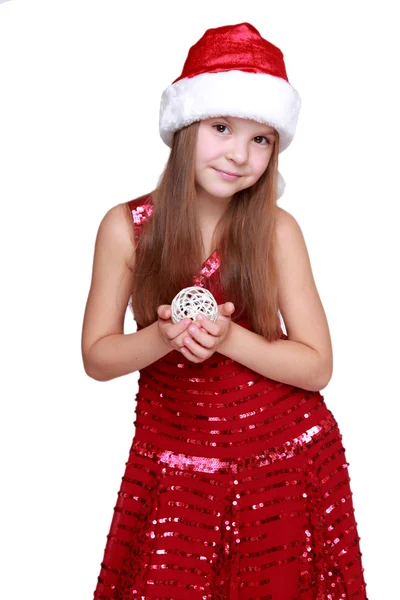 Girl holding Christmas decoration in hands — Stock Photo, Image