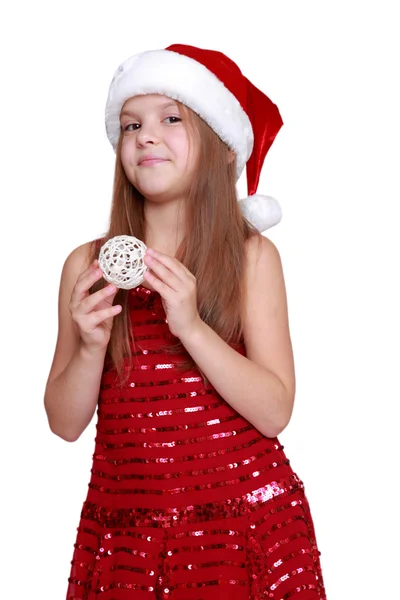 Girl holding Christmas decoration in hands — Stock Photo, Image