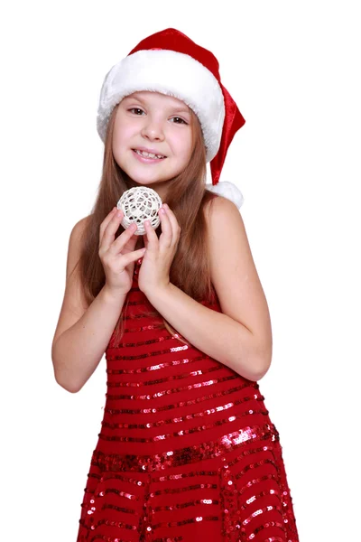 Girl holding Christmas decoration in hands — Stock Photo, Image