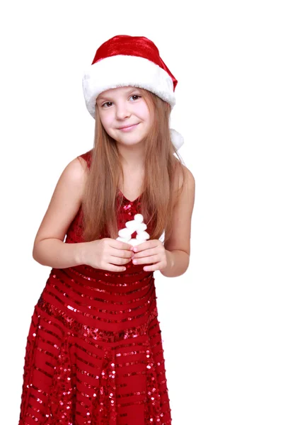 Meisje gekleed in een rode jurk en rode kerstmuts — Stockfoto