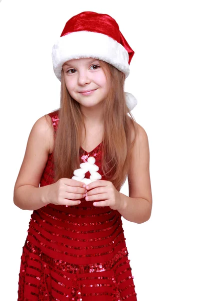小姑娘穿着一件红色的连衣裙和红色的圣诞老人的帽子 — 图库照片