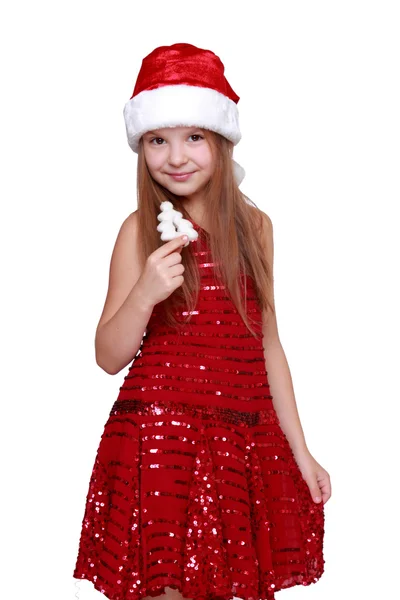 Mädchen in rotem Kleid und rotem Weihnachtsmann-Hut — Stockfoto