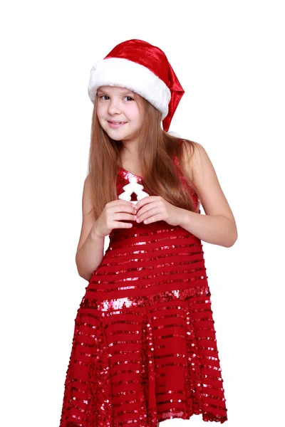 Meisje gekleed in een rode jurk en rode kerstmuts — Stockfoto