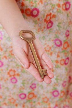 küçük kız el ile eski bir anahtar