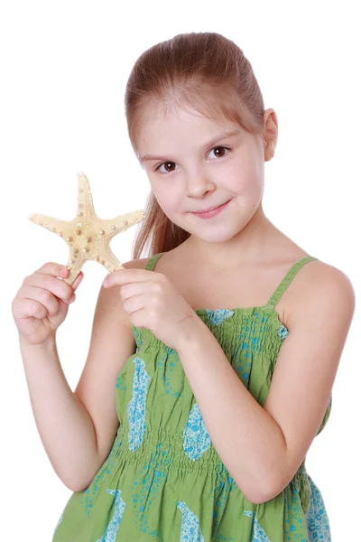 Küçük kız büyük bir deniz yıldızı tutar — Stok fotoğraf