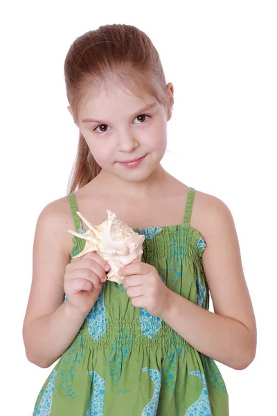 Girl holding a beautiful seashell — Stock Photo, Image