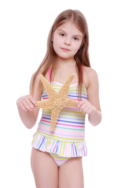 Girl with a starfish in her hands — Stock Photo, Image