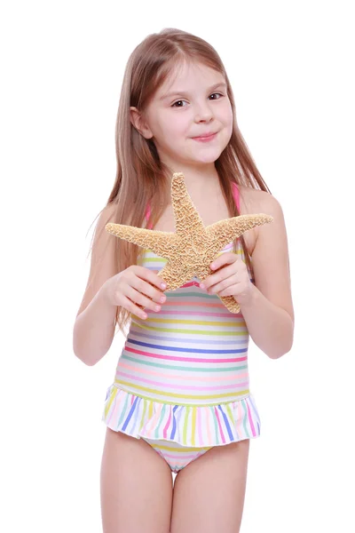 Girl with a starfish in her hands — Stock Photo, Image