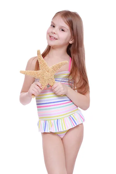 Girl with a starfish in her hands — Stock Photo, Image