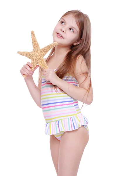 Girl with a starfish in her hands — Stock Photo, Image