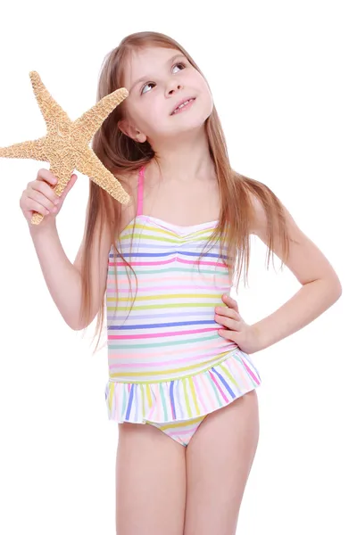 Menina com uma estrela do mar nas mãos — Fotografia de Stock