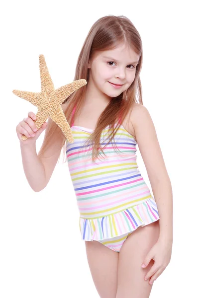 Girl with a starfish in her hands — Stock Photo, Image