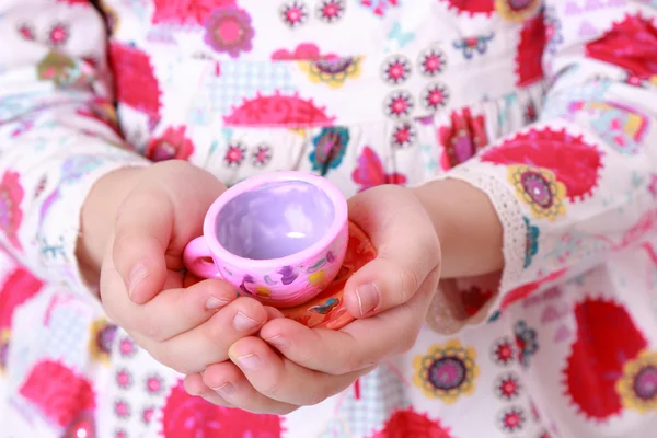 Toy cup in hand — Stock Photo, Image