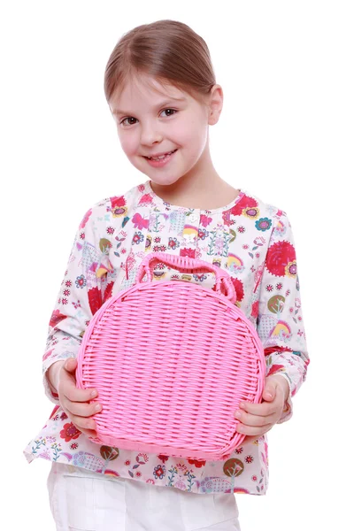 Girl with a pink basket — Stock Photo, Image