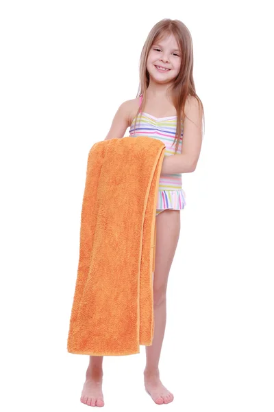 Little girl in swimsuit holding towel — Stock Photo, Image