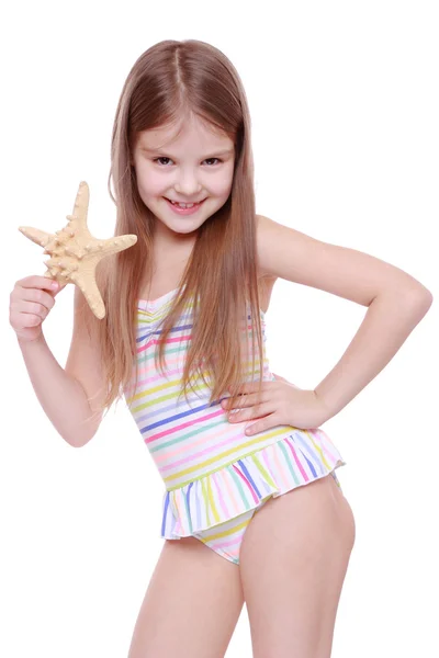 Girl in swimsuit with sea star — Stock Photo, Image