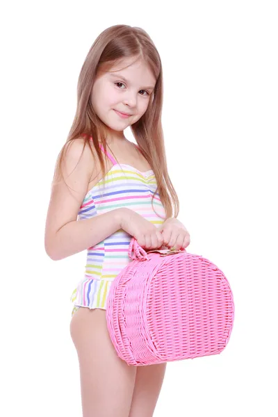 Little girl in swimsuit with basket — Stock Photo, Image