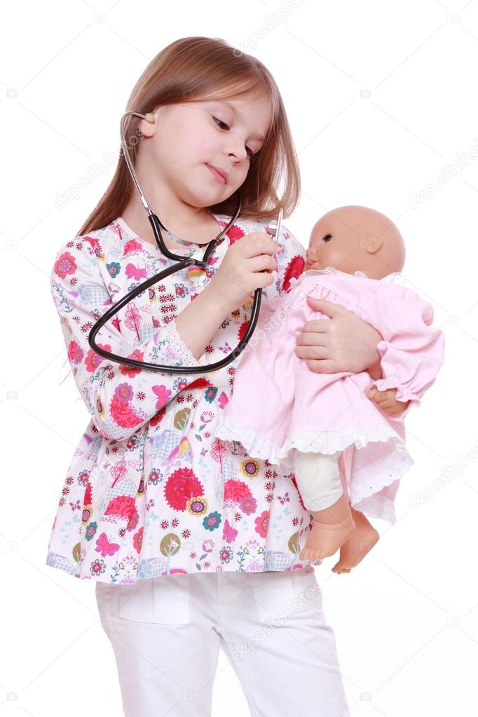 Child playing with toy doll