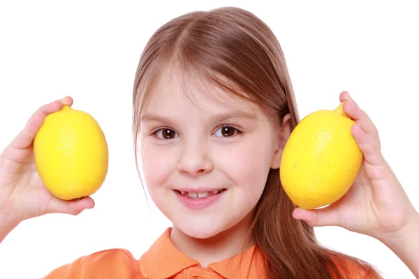 Little girl with fresh yellow lemons — Stock Photo, Image