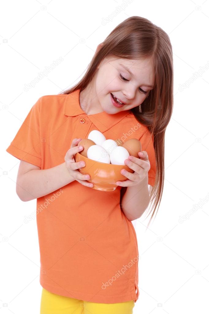 Girl holding a bowl of eggs