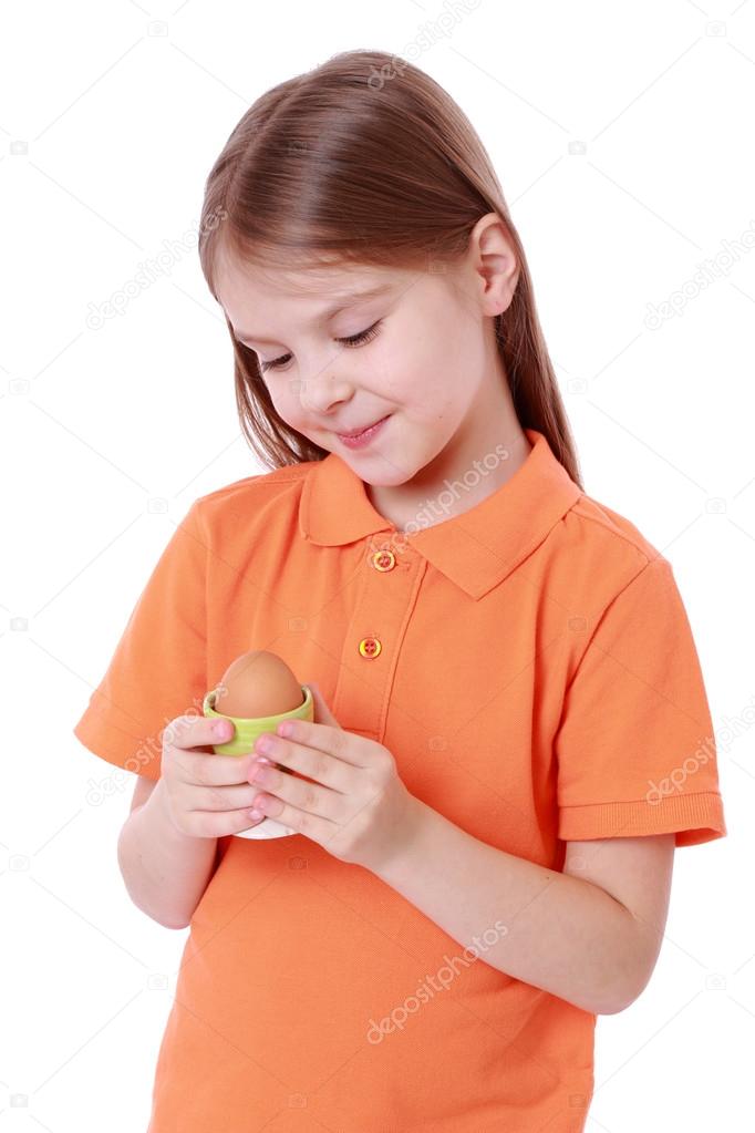 Little girl holding an egg