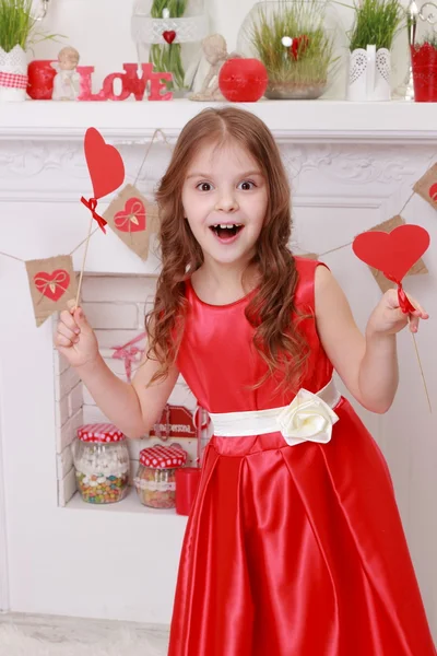 Girl over Valentine 's holding hearts — стоковое фото