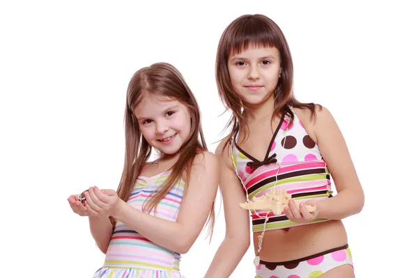 Girls holding starfish and shell — Stock Photo, Image