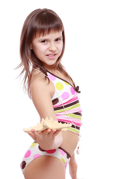 Girl in a swimsuit holding a starfish — Stock Photo, Image