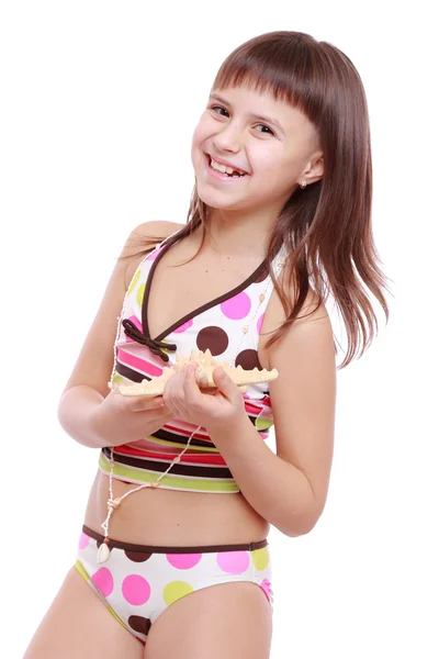 Girl in a swimsuit holding a starfish — Stock Photo, Image