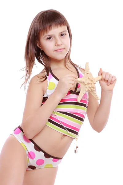 Girl in a swimsuit holding a starfish — Stock Photo, Image