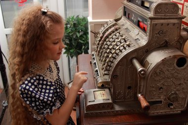 Girl and an old cash register clipart