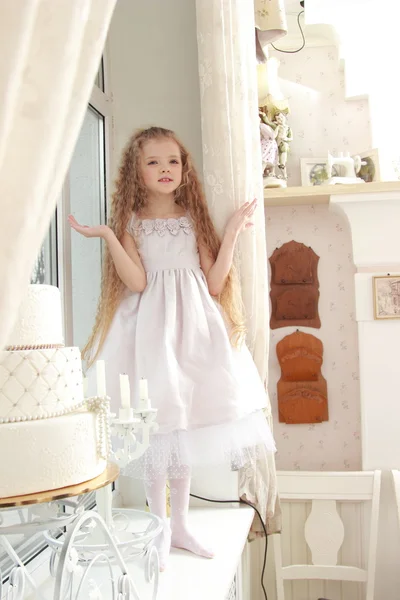 Three-tiered cake and a girl — Stock Photo, Image