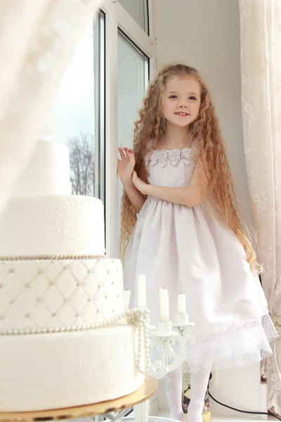 Three-tiered cake and a girl — Stock Photo, Image