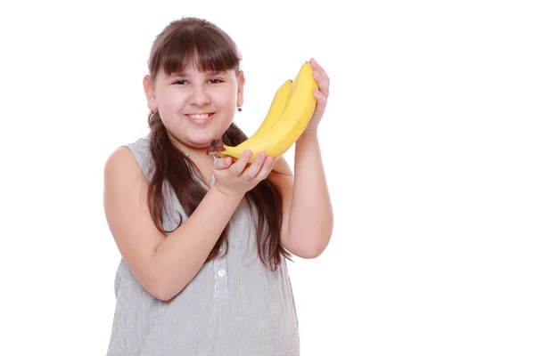 Meisje bedrijf bananen — Stockfoto