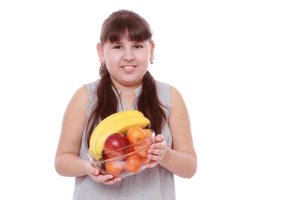 Girl holding a bowl of fruit — Stock Photo, Image