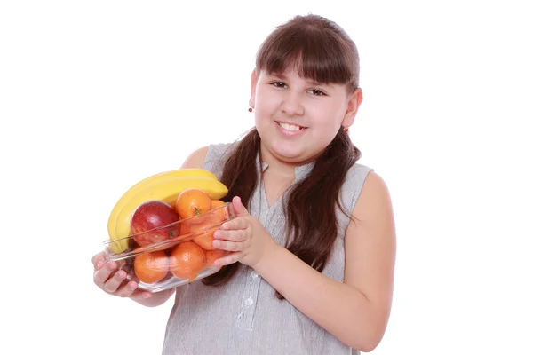 Girl holding a bowl of fruit — Stock Photo, Image