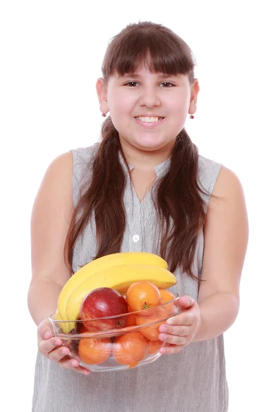 Girl holding a bowl of fruit — Stock Photo, Image