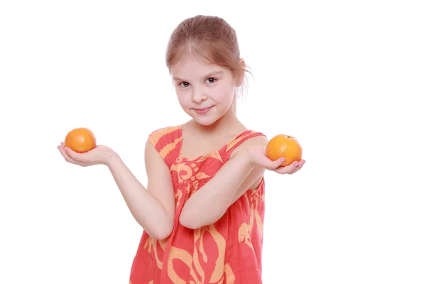 Girl holding mandarins — Stock Photo, Image