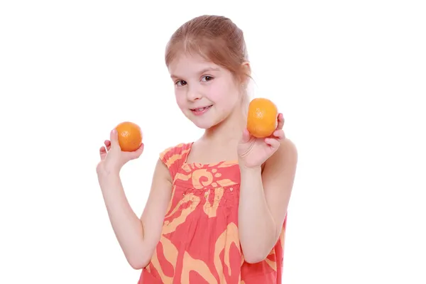 Girl holding mandarins — Stock Photo, Image