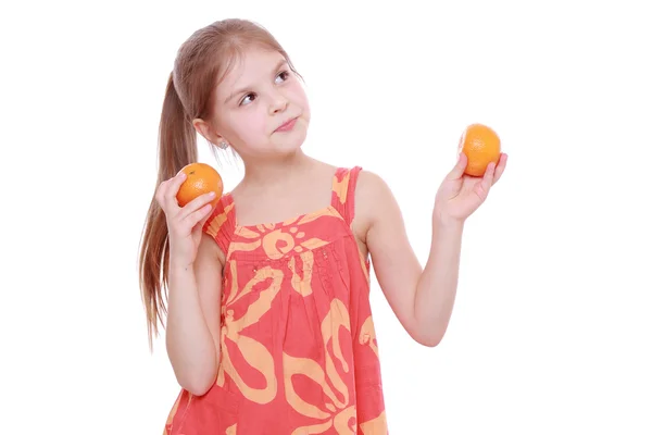 Girl holding mandarins — Stock Photo, Image